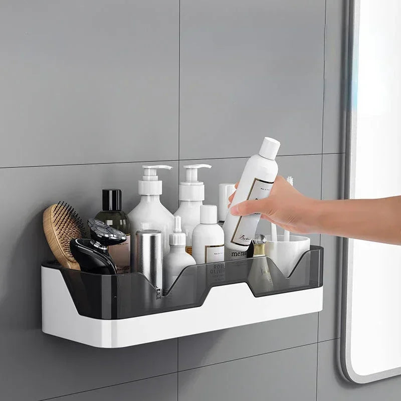 Hand reaching for a bottle of shampoo on a wall-mounted bathroom shelf.