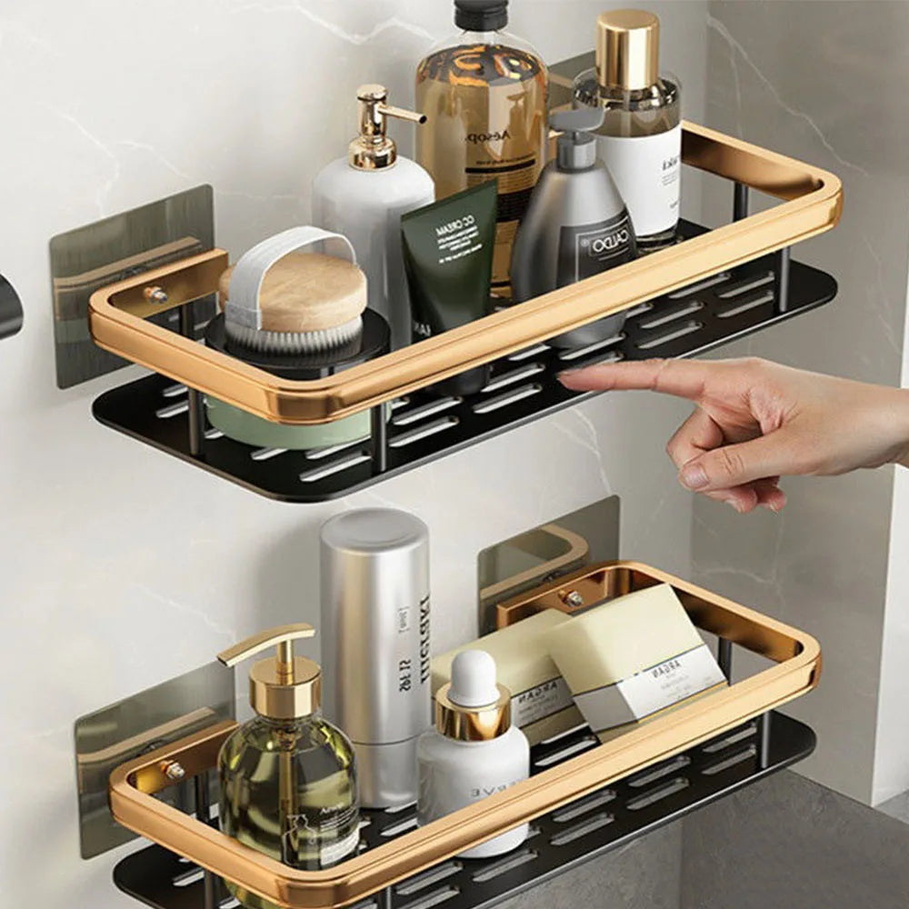 Wall-mounted gold stainless bathroom corner caddy organizer with two sleek black storage shelves for toiletries