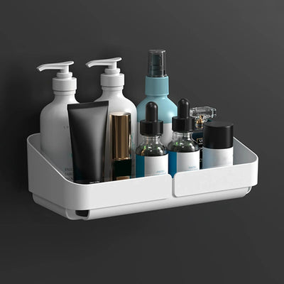 Small white shower caddy attached to bathroom wall using adhesive stickers.