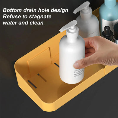 Close-up view of yellow small shower caddy with bottom drain slots for water flow